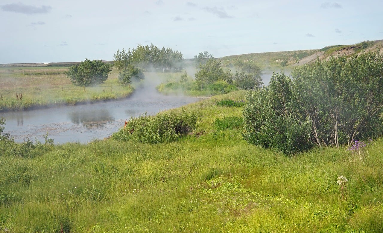 Steaming geothermal spring landscape representing Deildartunguhver in West Iceland
