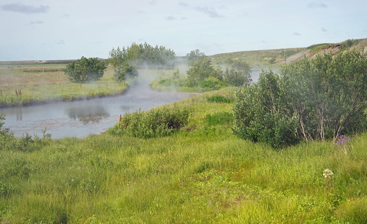Steaming geothermal spring landscape representing Deildartunguhver in West Iceland