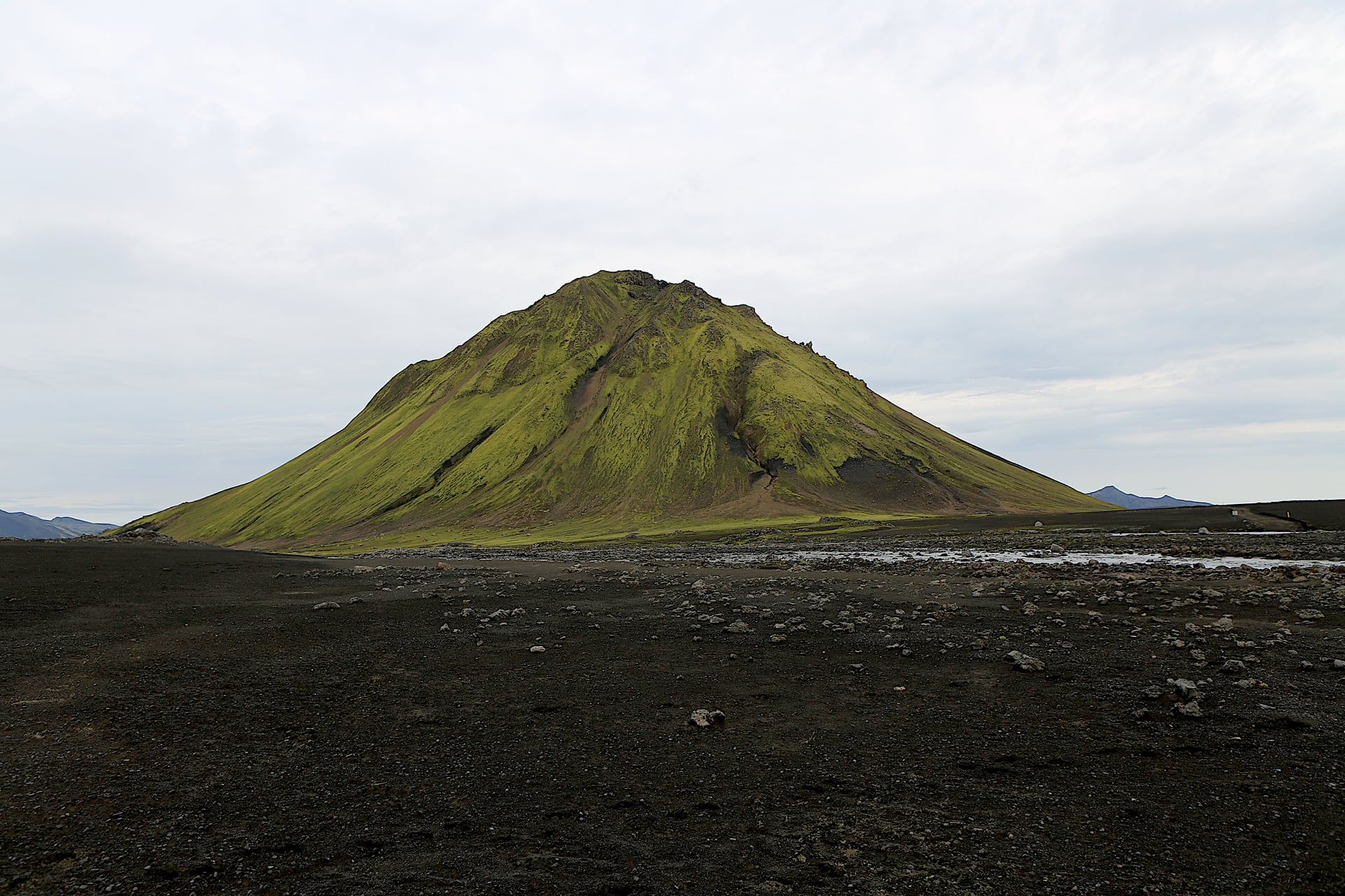 Mælifell mountain rising from black sand in South Iceland