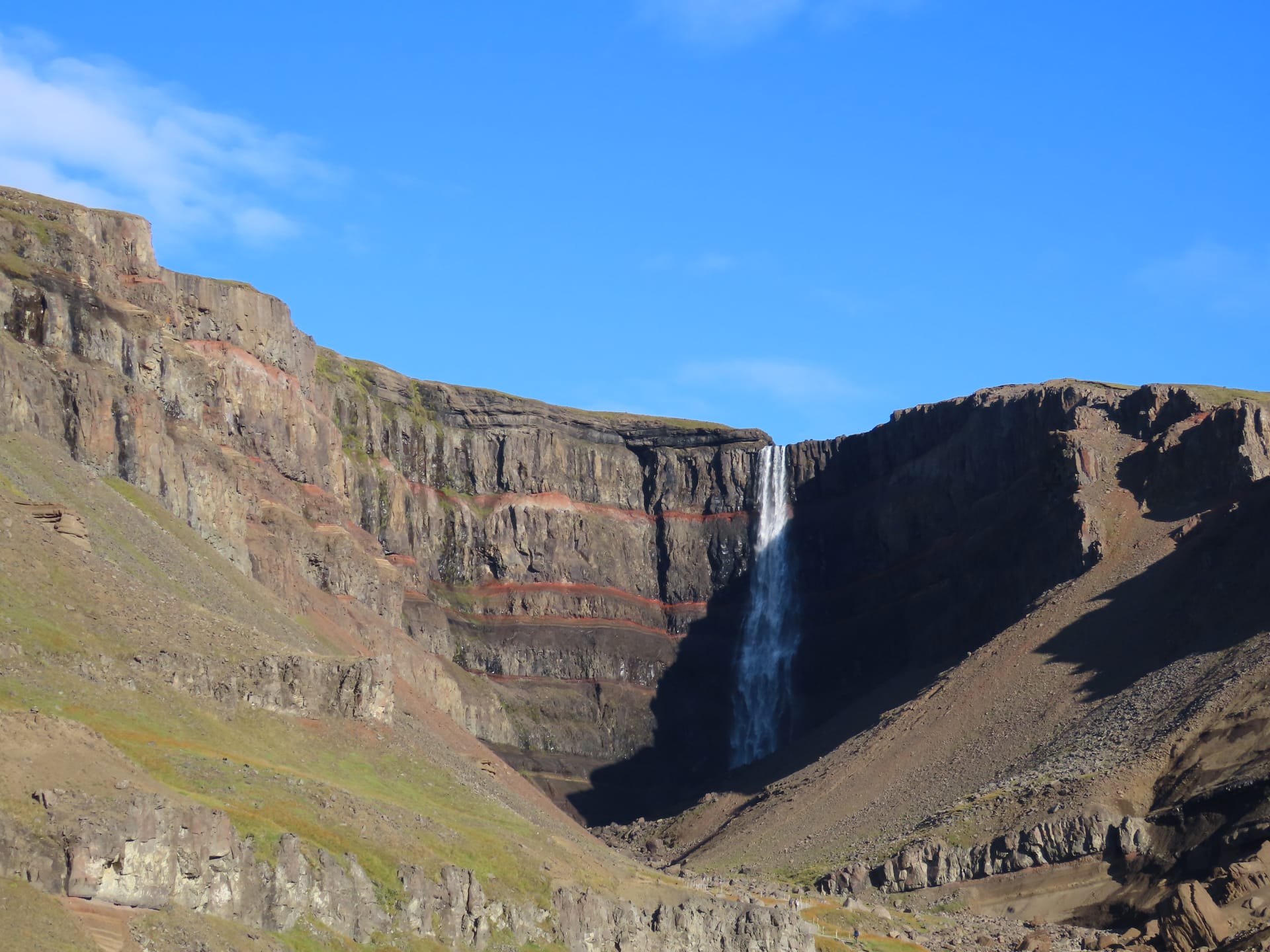 Hengifoss waterfall with red layered cliffs in East Iceland