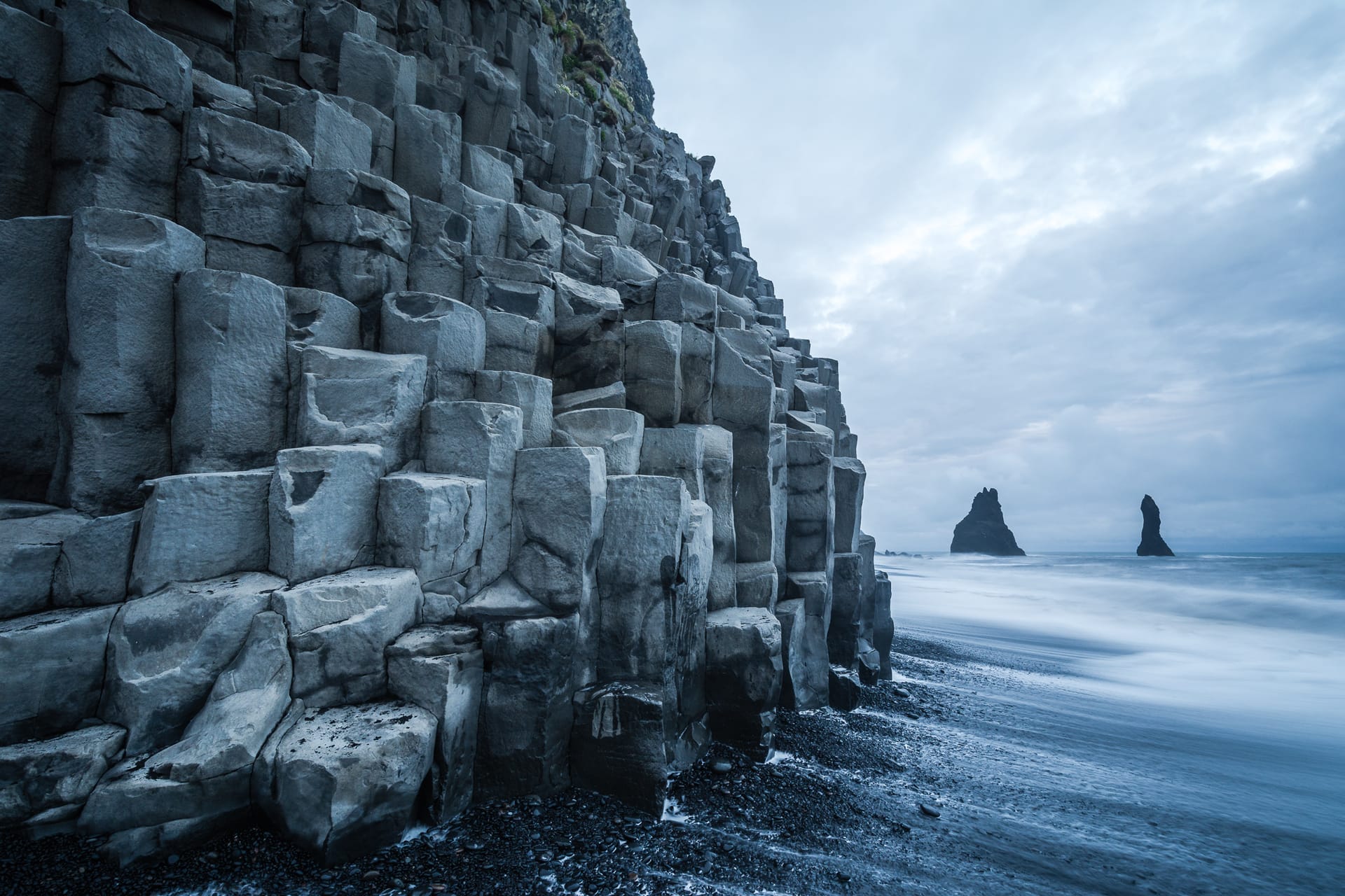 View from basalt rocks at Reynisfjara toward Reynisdrangar on Iceland's South Coast