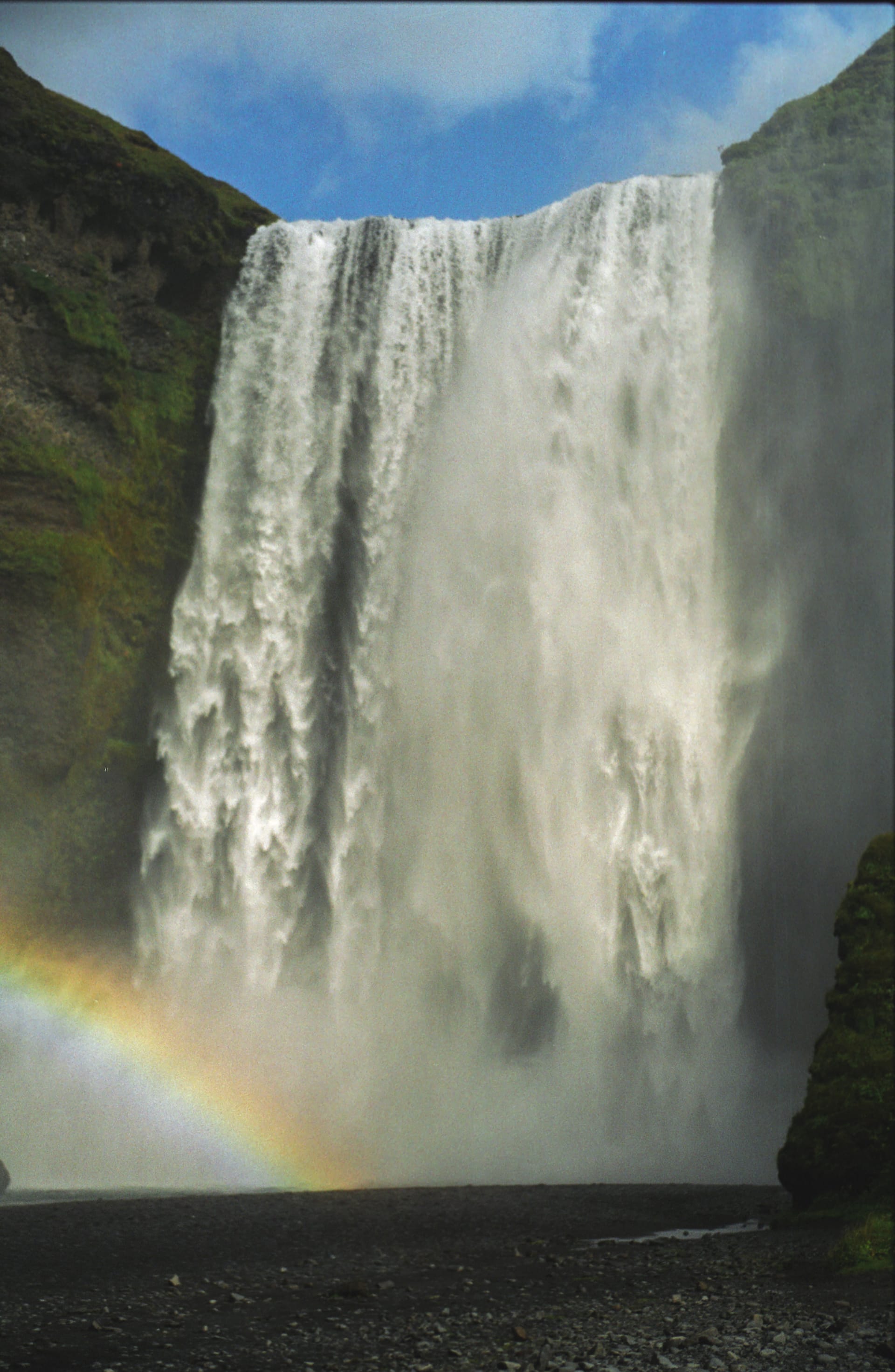 Skogafoss waterfall with rainbow mist on Iceland's South Coast